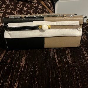 Tan and black clutch
